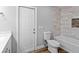Bathroom featuring a tiled shower, tub, and an access door to the exterior at 7359 Van Lake Dr, Englewood, FL 34224