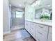 Elegant bathroom features a glass enclosed shower and vanity with double sinks and modern fixtures at 7359 Van Lake Dr, Englewood, FL 34224