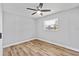 Bedroom featuring a ceiling fan, hardwood floors, and a bright window at 7359 Van Lake Dr, Englewood, FL 34224