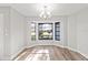 Bright dining area featuring a bay window, hardwood floors, and a modern chandelier at 7359 Van Lake Dr, Englewood, FL 34224