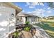 Inviting single-story home featuring a well-manicured lawn and a welcoming front porch area at 7359 Van Lake Dr, Englewood, FL 34224