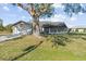 Charming single-story home with a mature tree in the front yard providing plenty of shade at 7359 Van Lake Dr, Englewood, FL 34224