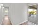 Hallway featuring hardwood floors leading to an enclosed patio and a view of the pool at 7359 Van Lake Dr, Englewood, FL 34224