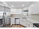 Modern kitchen with white cabinets and stainless steel appliances at 7359 Van Lake Dr, Englewood, FL 34224