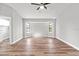 Bright living room with bay window and wood-look floors at 7359 Van Lake Dr, Englewood, FL 34224