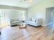 Bright living room featuring neutral paint, modern couches, and hardwood floors at 7359 Van Lake Dr, Englewood, FL 34224