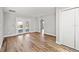 Bright and airy living room with wood-look flooring and access to the patio at 7359 Van Lake Dr, Englewood, FL 34224