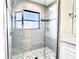 Elegant shower featuring tile walls and flooring with a glass door and a window at 7359 Van Lake Dr, Englewood, FL 34224