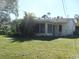 Another view of the house's back, showing a screened porch and yard at 850 Cordele Nw Ave, Port Charlotte, FL 33948