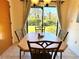 Bright dining room with wood table and chairs, overlooking a grassy backyard at 87 Boundary Blvd # 3, Rotonda West, FL 33947