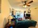 Living room with teal couches, coffee table, and a view into the dining area at 87 Boundary Blvd # 3, Rotonda West, FL 33947