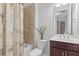 Bathroom with a shower/tub combo, a vanity sink, and a tropical-themed shower curtain at 8882 Peregrine Way, North Port, FL 34287