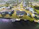 Aerial view showcasing home, dock, and canal at 130 Arlington Ne Ct, Port Charlotte, FL 33952