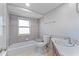 Bathroom featuring an updated vanity, tub, and shower at 130 Arlington Ne Ct, Port Charlotte, FL 33952