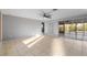 Open bedroom featuring tile flooring, fan, and glass doors to the lanai at 130 Arlington Ne Ct, Port Charlotte, FL 33952