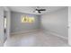 Neutral bedroom with fan, tile floor, and a window offering natural light at 130 Arlington Ne Ct, Port Charlotte, FL 33952
