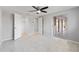 Bedroom boasts tile flooring, a ceiling fan, closet, and access to the bright and open sunroom at 130 Arlington Ne Ct, Port Charlotte, FL 33952