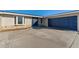 Home's front entrance with a blue garage door at 130 Arlington Ne Ct, Port Charlotte, FL 33952