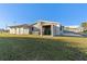 House exterior with storage shed and grassy yard at 130 Arlington Ne Ct, Port Charlotte, FL 33952