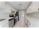 Long kitchen with stainless steel appliances at 130 Arlington Ne Ct, Port Charlotte, FL 33952