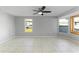 Living room with tile floors, large windows, and ceiling fan at 130 Arlington Ne Ct, Port Charlotte, FL 33952