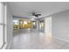 Living room with tile floors, bay window and ceiling fan, offering water views at 130 Arlington Ne Ct, Port Charlotte, FL 33952