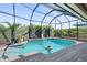 Inviting screened-in pool with a fountain and plenty of surrounding space at 1310 Monte Carlo Ct, Punta Gorda, FL 33950