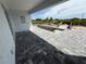 New backyard patio area and in-ground pool under construction, with stylish gray pavers and bright white home at 13541 Jeronimo Ln, Port Charlotte, FL 33981