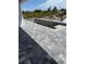 Home features concrete pool under construction, patio with stone pavers, and drainage system at 13541 Jeronimo Ln, Port Charlotte, FL 33981