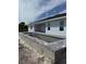 New construction backyard pool features sleek lines, a tanning ledge and a modern brick surround at 13541 Jeronimo Ln, Port Charlotte, FL 33981