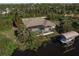 Aerial view of house with pool and private dock, showcasing waterfront property at 15600 Aldama Cir, Port Charlotte, FL 33981