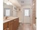 Guest bathroom with a single vanity and exterior access at 15600 Aldama Cir, Port Charlotte, FL 33981