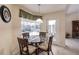 Cozy breakfast nook featuring a glass-top table, comfortable seating, and views of the screened-in pool area at 15600 Aldama Cir, Port Charlotte, FL 33981