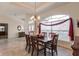 Elegant dining room with hardwood table, chandelier, and large window at 15600 Aldama Cir, Port Charlotte, FL 33981