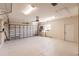 Spacious two-car garage with high ceilings, window, water system, and utility door to exterior at 15600 Aldama Cir, Port Charlotte, FL 33981