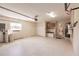 Clean garage with utility sink, overhead lighting, storage cabinets, and interior door to home at 15600 Aldama Cir, Port Charlotte, FL 33981