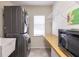 Laundry room featuring front load washer and dryer, sink, shelving, storage, and counterspace at 15600 Aldama Cir, Port Charlotte, FL 33981