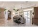 Inviting living room featuring neutral tones, tile floors, comfortable seating, and natural light at 15600 Aldama Cir, Port Charlotte, FL 33981