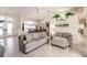 Spacious living room with tile flooring, comfortable seating, and large windows offering ample natural light at 15600 Aldama Cir, Port Charlotte, FL 33981