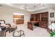 Well-lit office space with built-in bookshelves and a view of the kitchen area at 15600 Aldama Cir, Port Charlotte, FL 33981