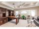 Spacious home office with large desk, comfortable seating, and ceiling fan at 15600 Aldama Cir, Port Charlotte, FL 33981