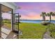 Screened patio overlooking a lake with sunset view at 15976 Shoreline Dr, Punta Gorda, FL 33982