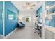 Bright home office with built-in shelving and blue walls at 15976 Shoreline Dr, Punta Gorda, FL 33982