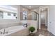 Luxurious bathroom with a soaking tub and a separate glass-enclosed shower at 16114 Highgate St, Port Charlotte, FL 33953