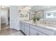 Bathroom featuring double vanities and a separate glass-enclosed shower at 16114 Highgate St, Port Charlotte, FL 33953