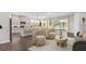 Open-concept living area with a kitchen island and backyard views at 16114 Highgate St, Port Charlotte, FL 33953