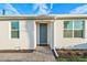 Gray front door with paver walkway and landscaping at 16891 Caracara Pl, Punta Gorda, FL 33982