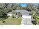 Aerial view of a single-Gathering house with a gray roof and a two-car garage at 17080 Kellog Ave, Port Charlotte, FL 33954