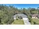 An aerial view of a house on a tree-lined street at 17080 Kellog Ave, Port Charlotte, FL 33954