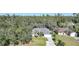 Aerial view showing a house nestled in a wooded neighborhood at 17080 Kellog Ave, Port Charlotte, FL 33954